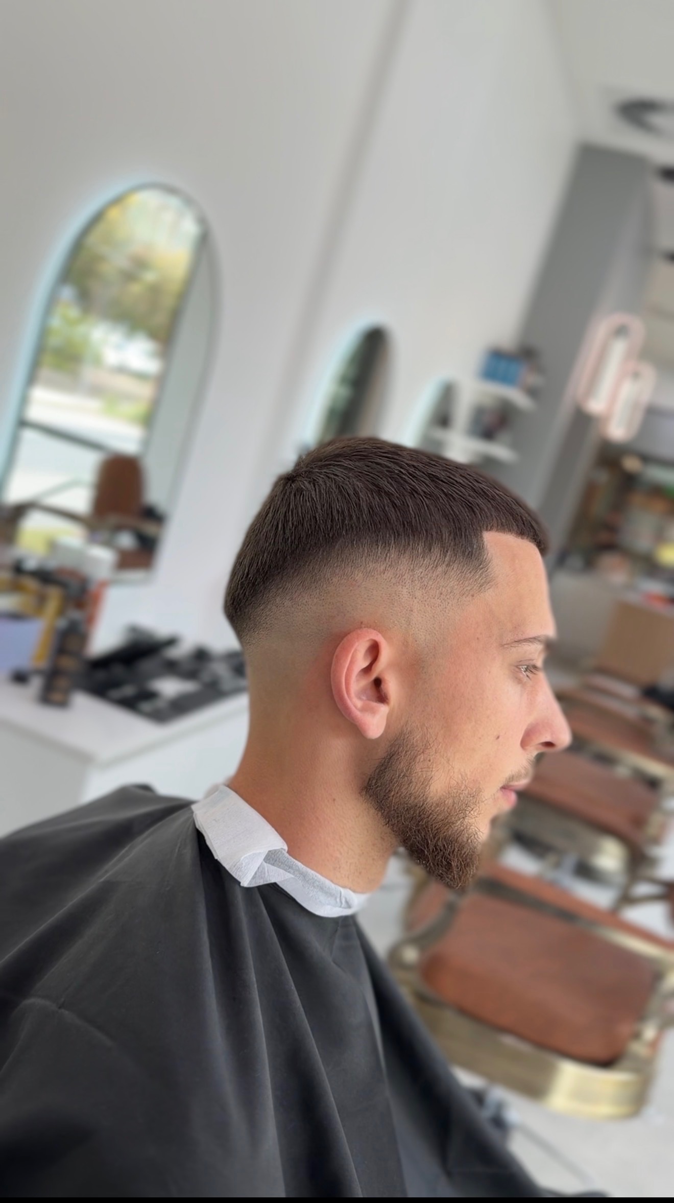 Low fade haircut with a sharp front line-up