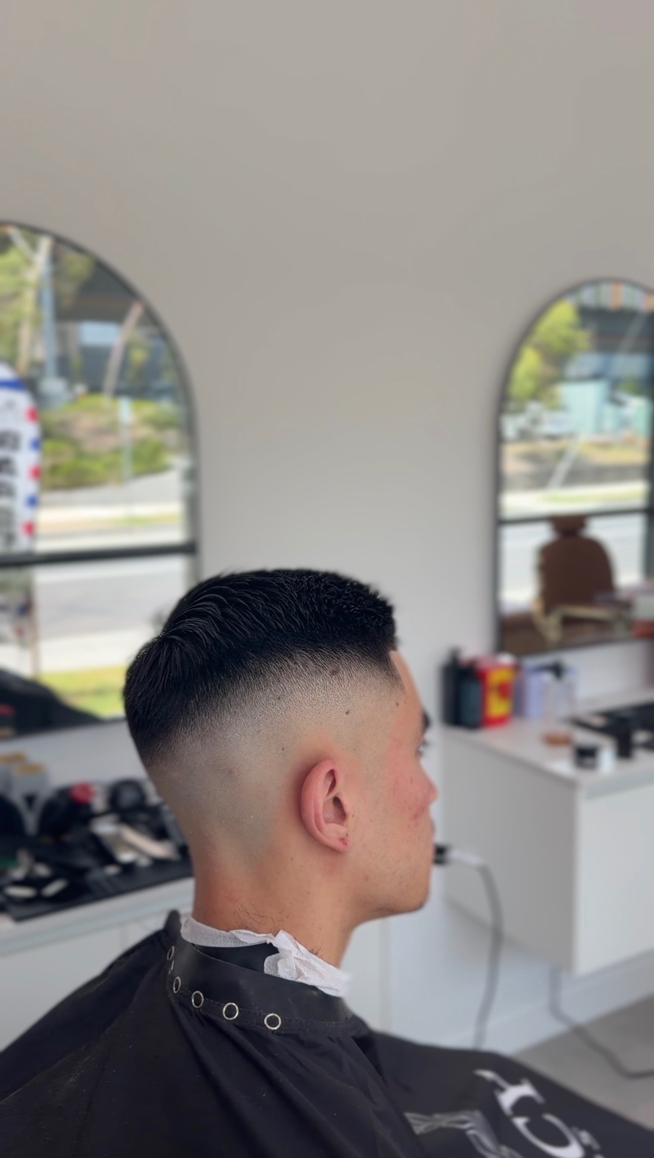 Clean skin fade blended into a short textured haircut