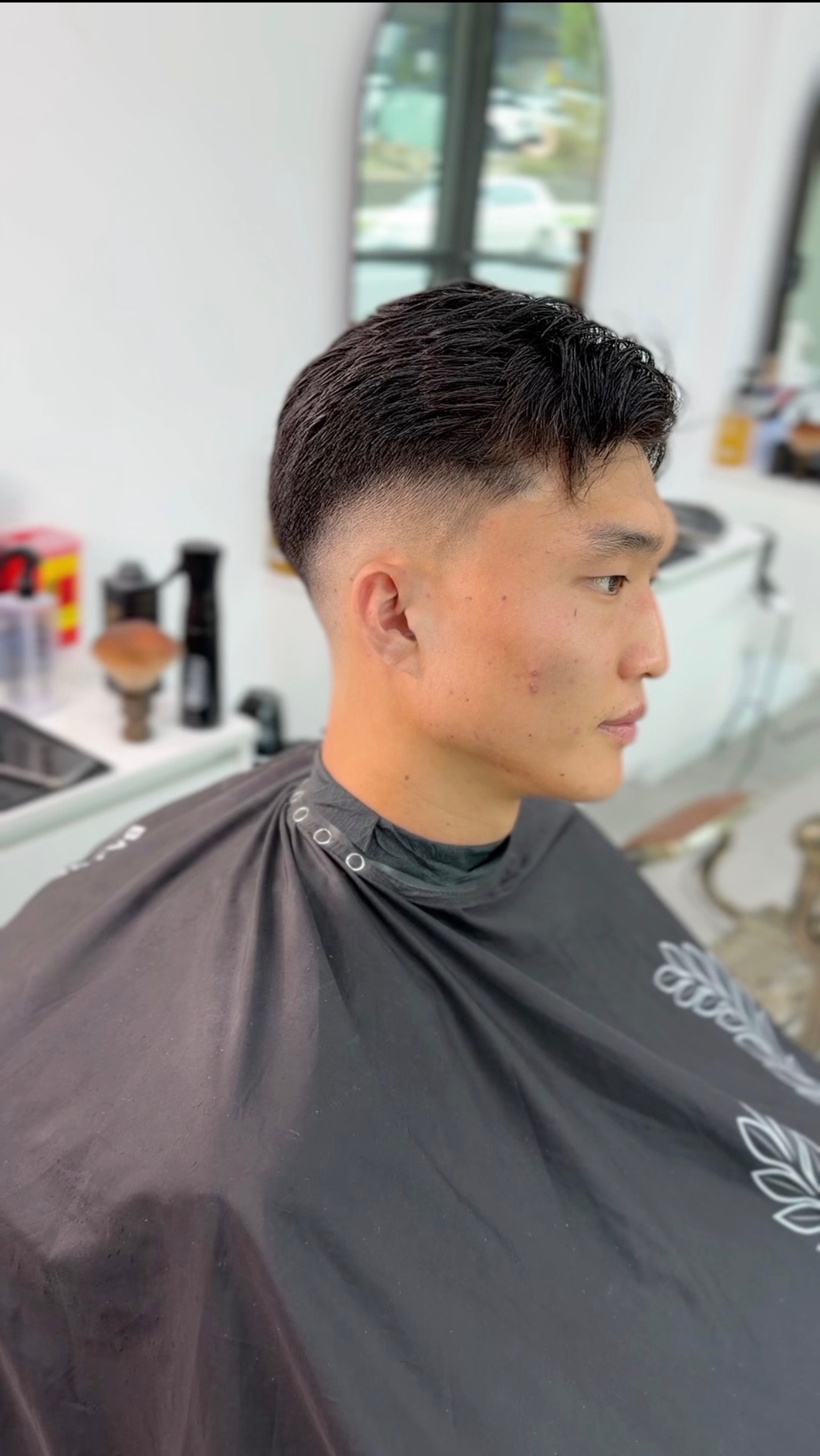 Classic fade haircut with a blended beard line
